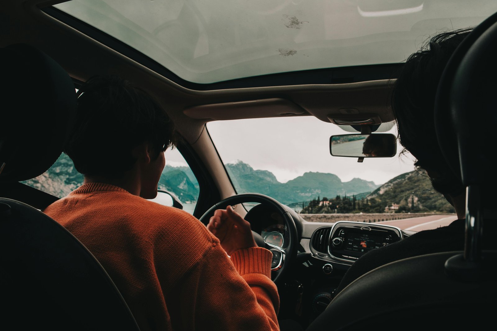Three professional colleagues carpooling in a car